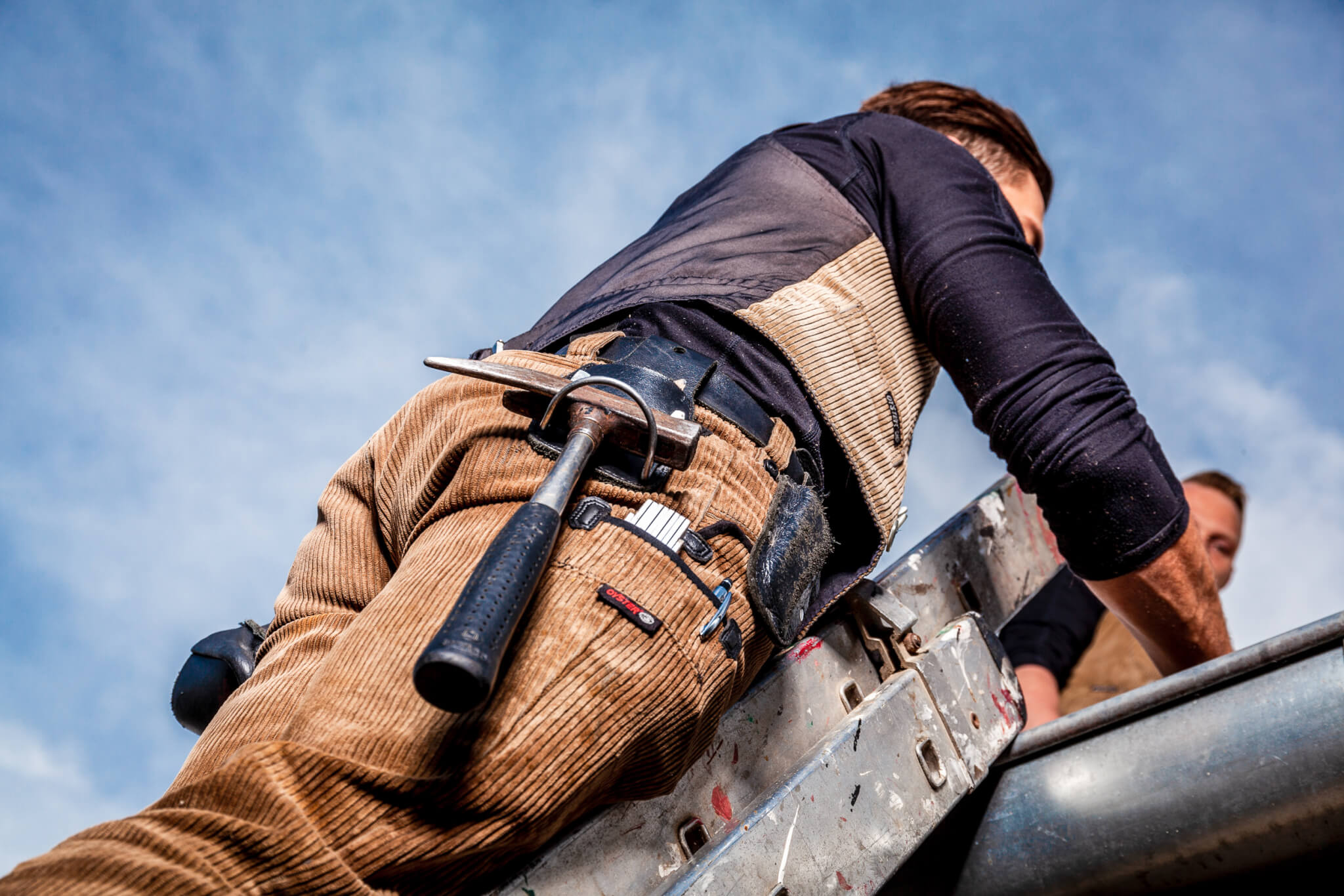 Dachdecker auf Leiter.